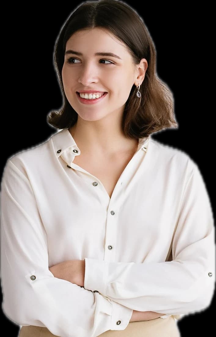 A smiling woman in a cream blouse with her arms crossed